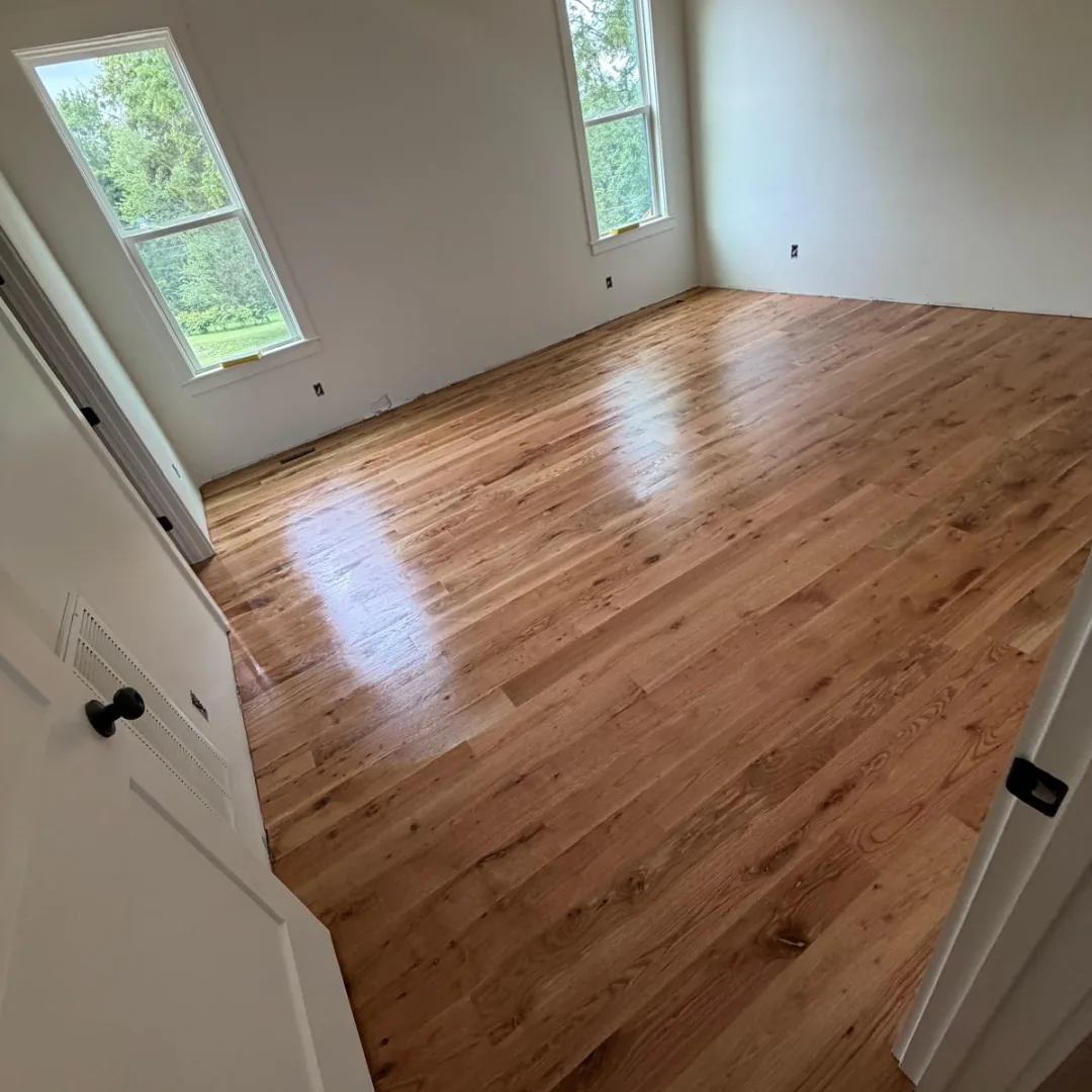 Newly installed hardwood flooring in empty room