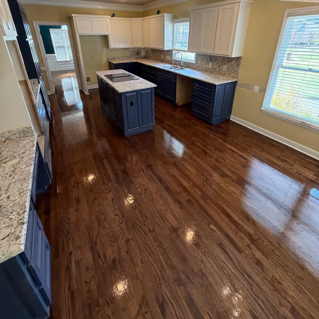 Dark hardwood flooring in a spacious kitchen.