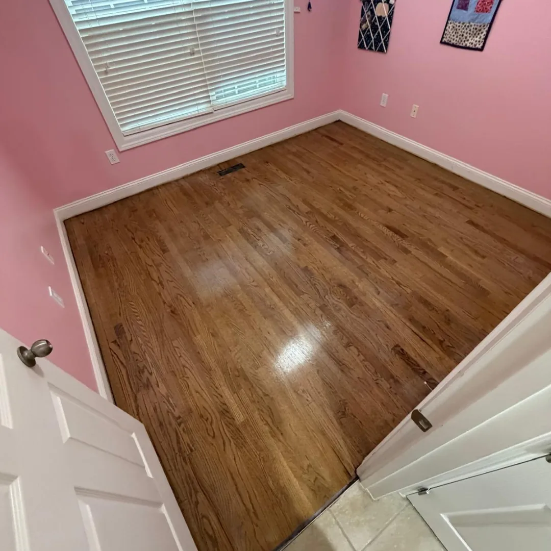 Refinished hardwood floor in a pink room
