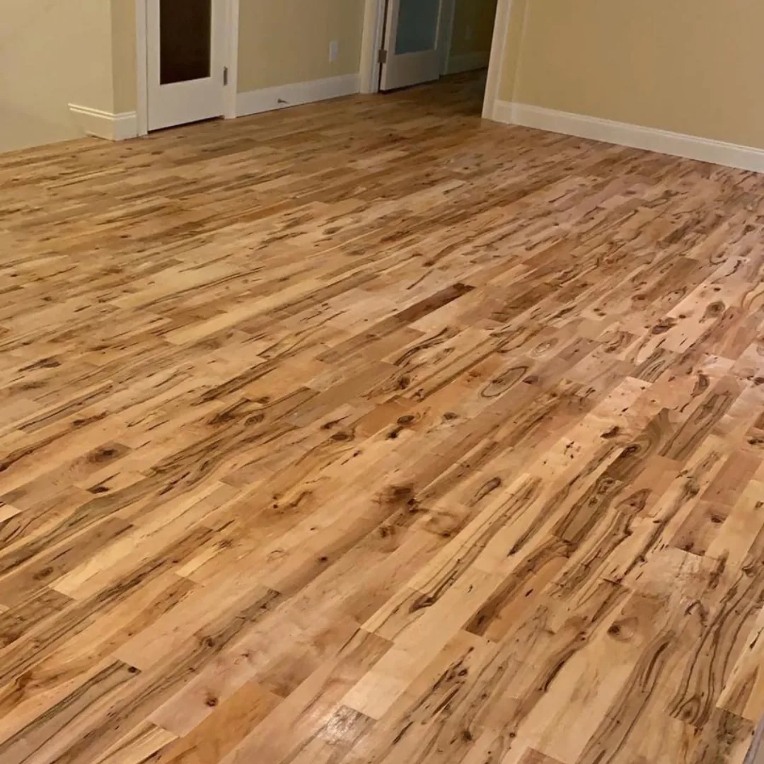 Newly installed light hardwood flooring with unique grain.