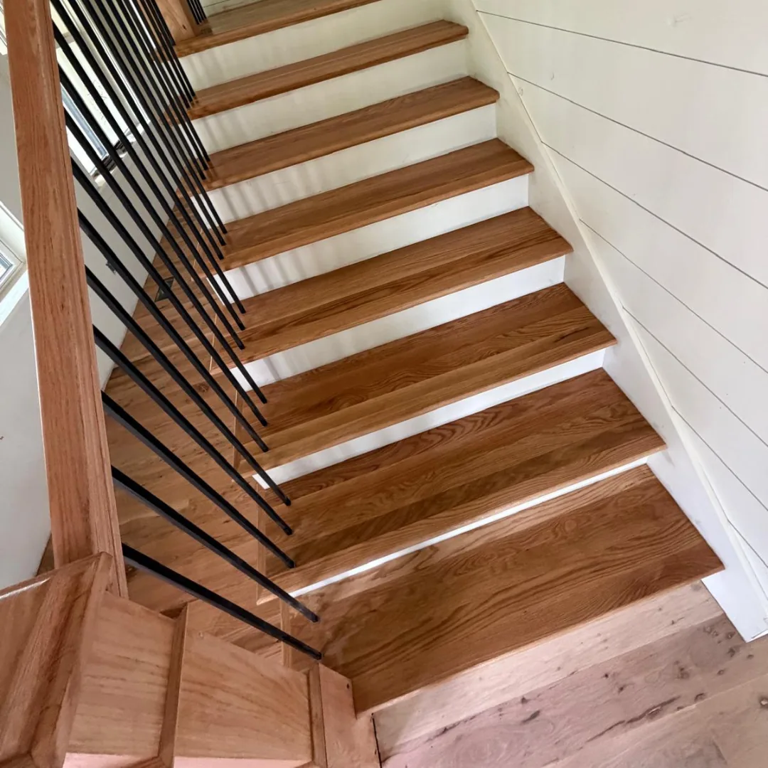 Modern wooden stairs with black railing