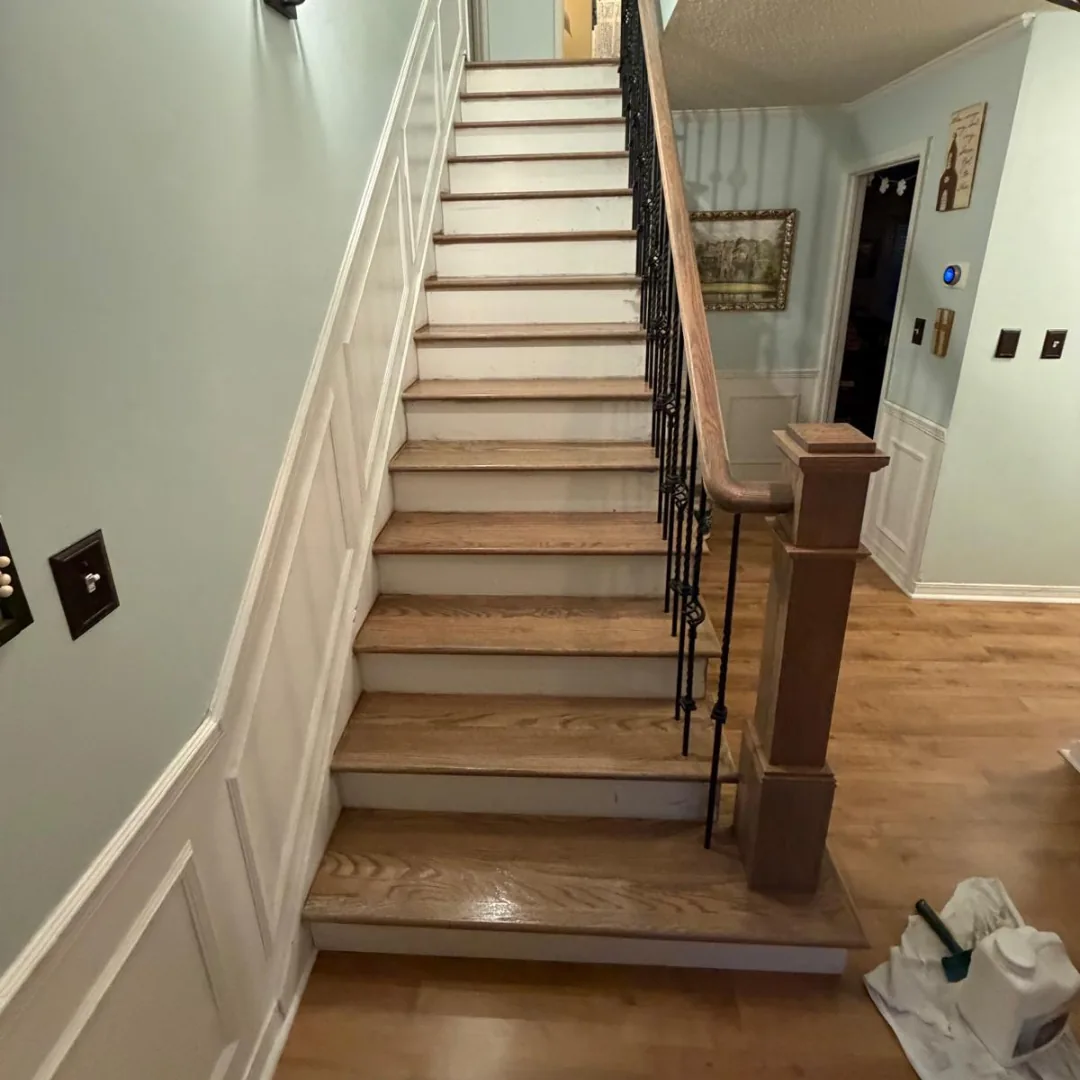 Refinished hardwood stairs with new balusters and railings.