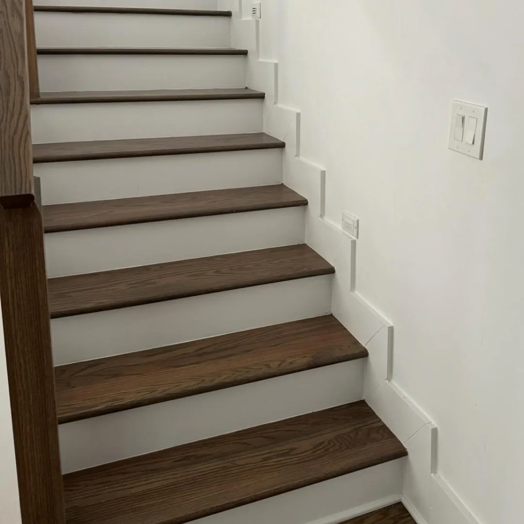 Hardwood stairs with white risers and trim.