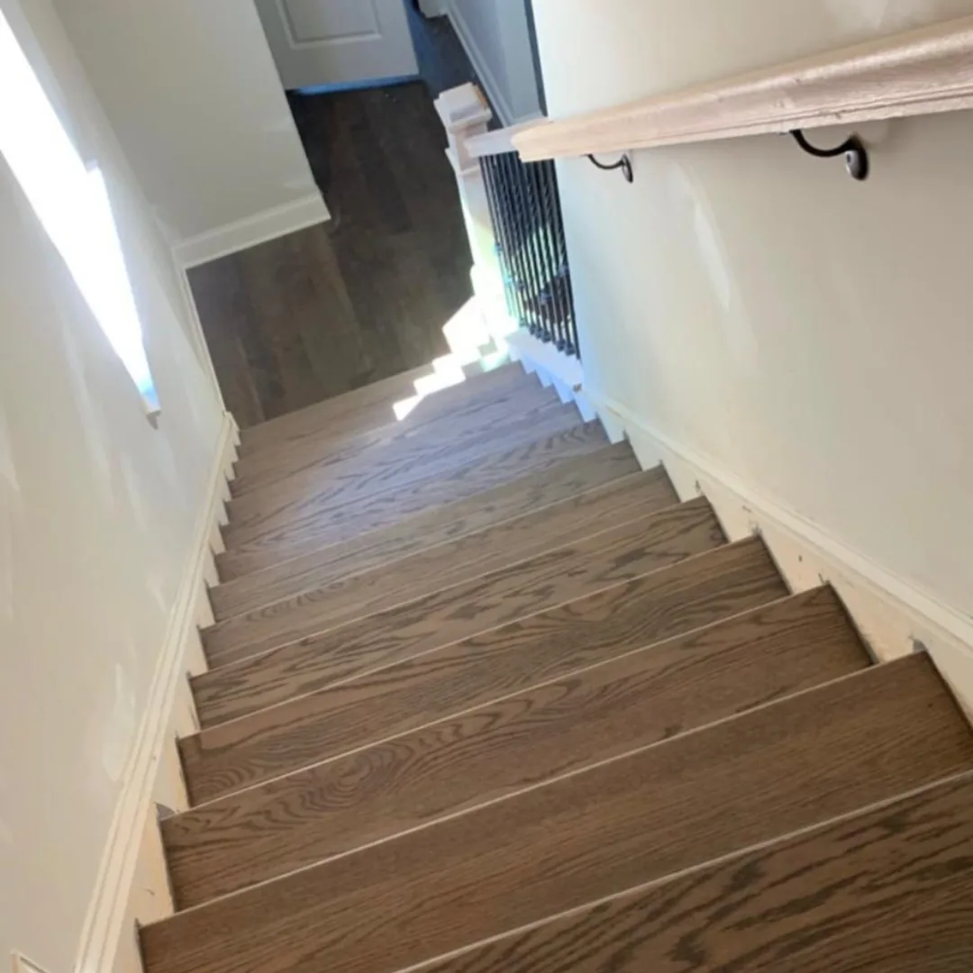 Newly installed hardwood stairs with railing