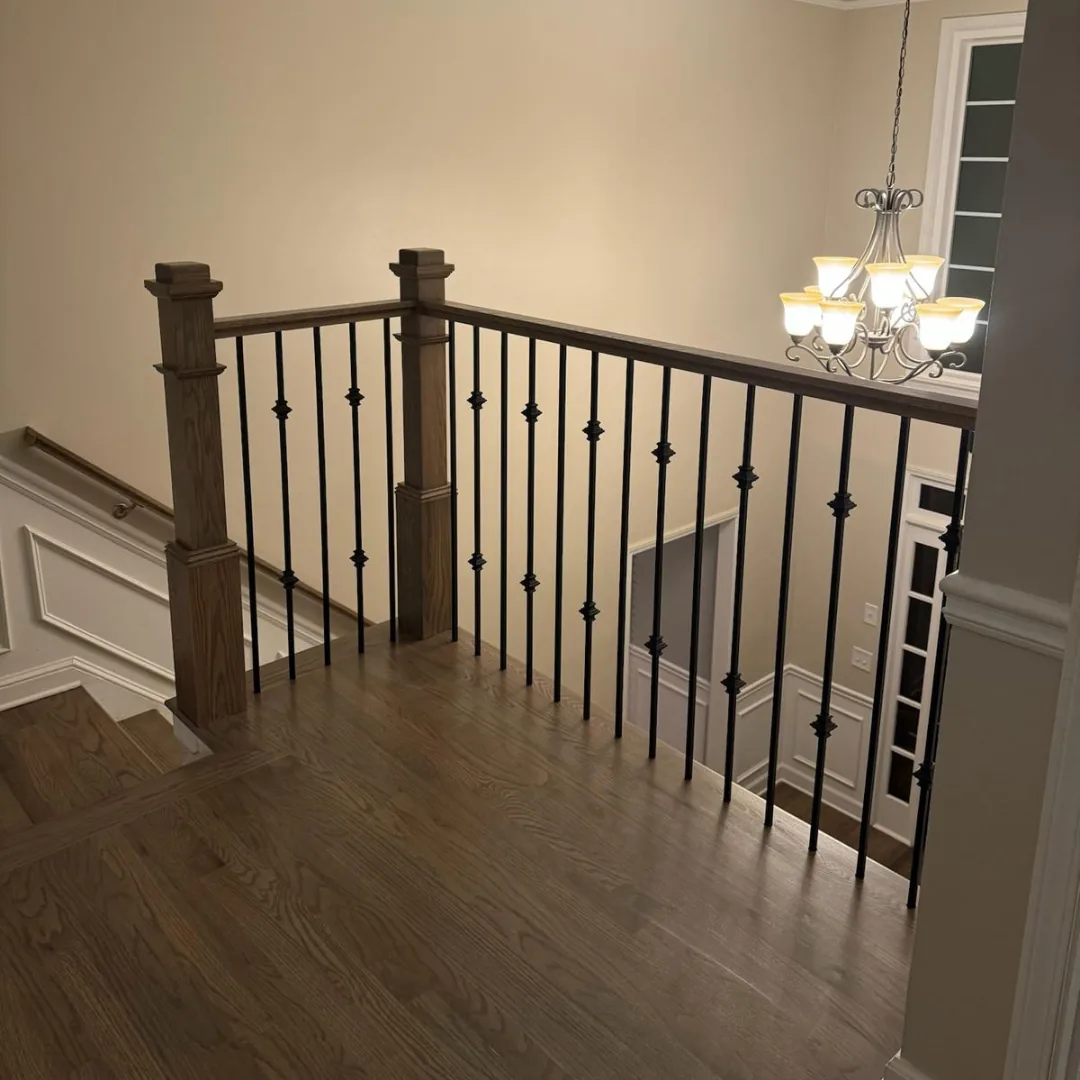 Stairs with hardwood, railings, and balusters