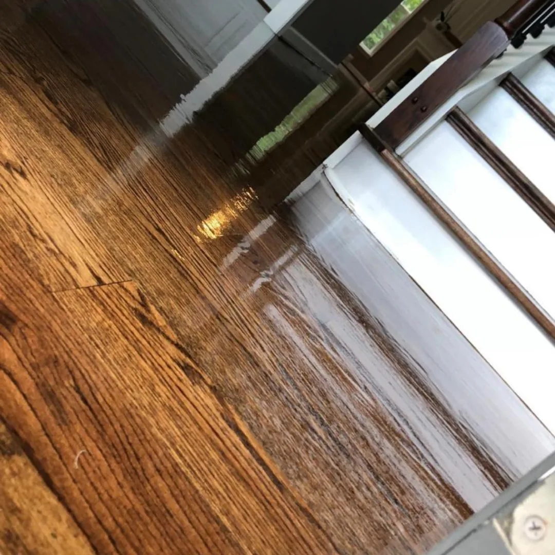 Newly refinished shiny hardwood floor and stairs.