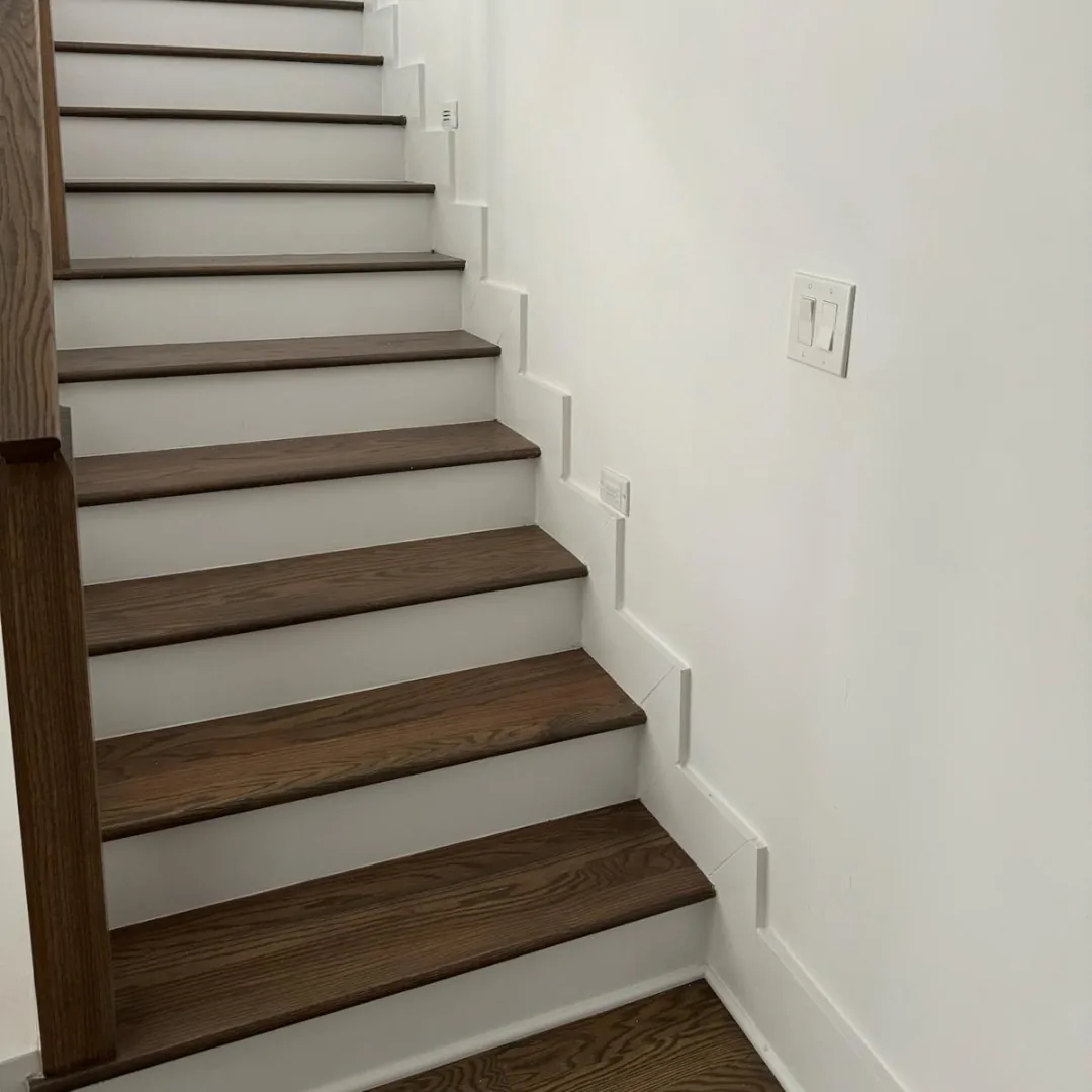 Hardwood stairs with white risers and trim.