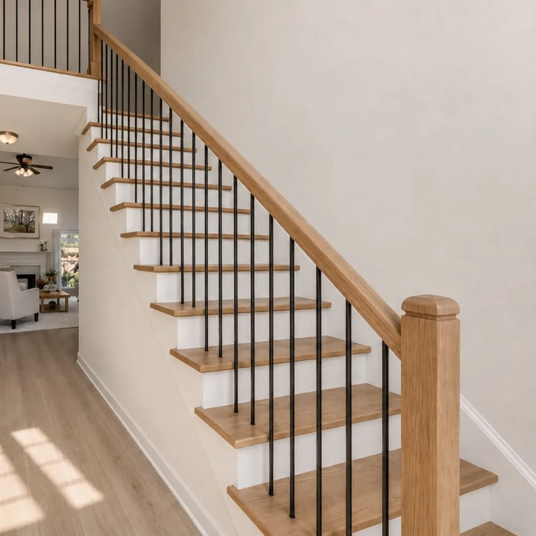 Oak staircase with hardwood treads, white risers and black metal balusters
