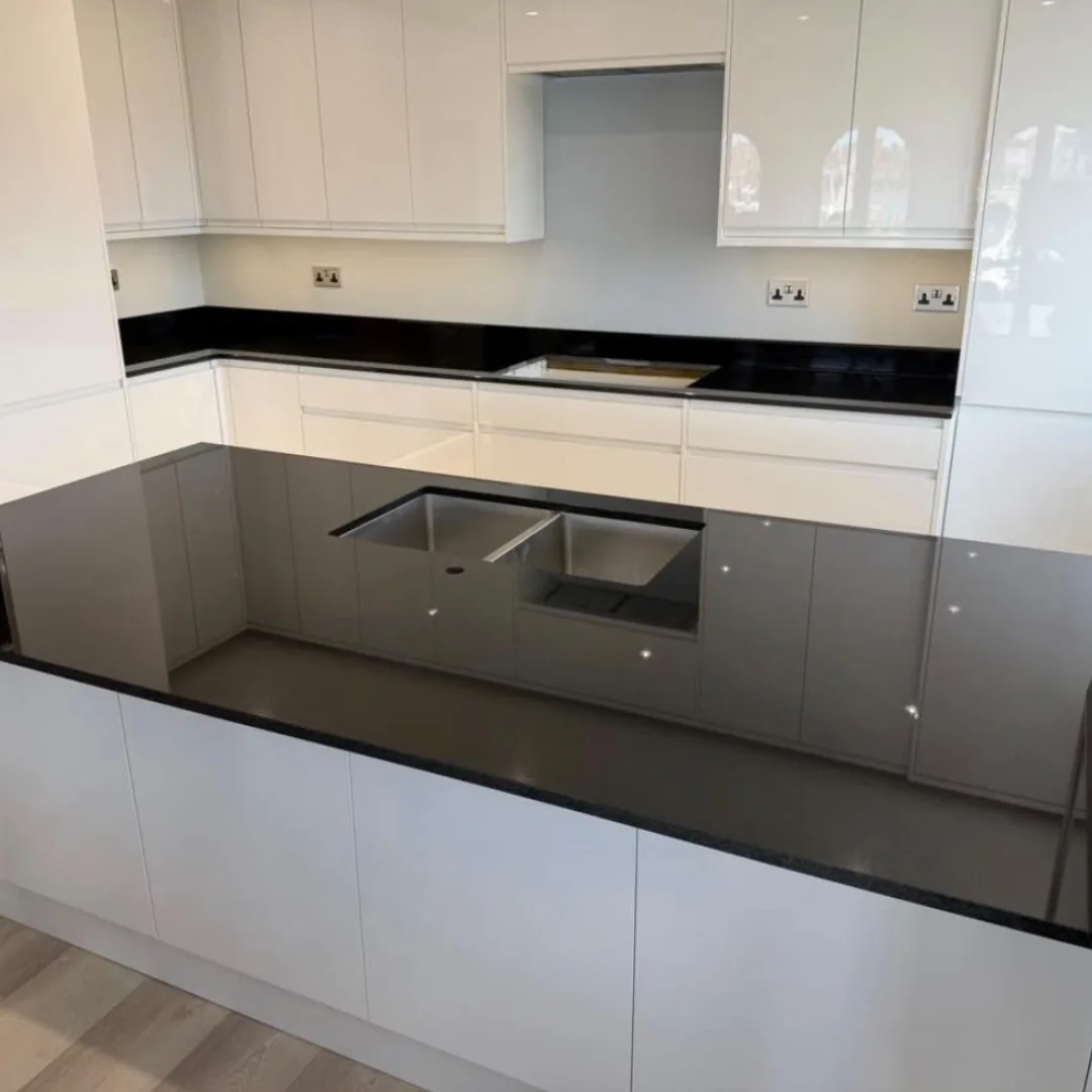 Modern kitchen with dark quartz countertops and an integrated sink