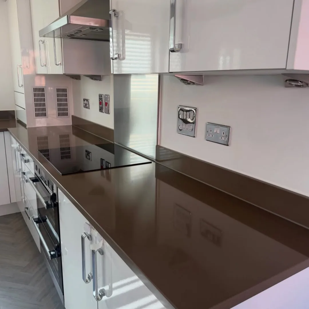Modern kitchen with stainless steel splashback and built-in ovens
